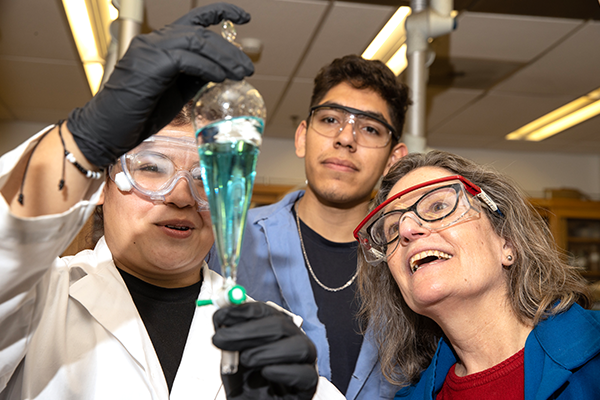 Cousins working with students in her lab