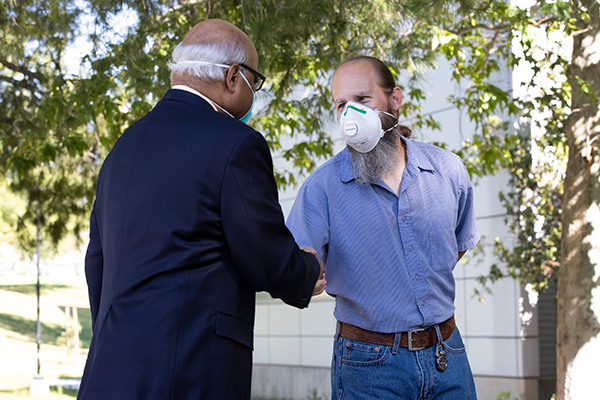 Sastry Pantula and Eric Melchiorre shake hands