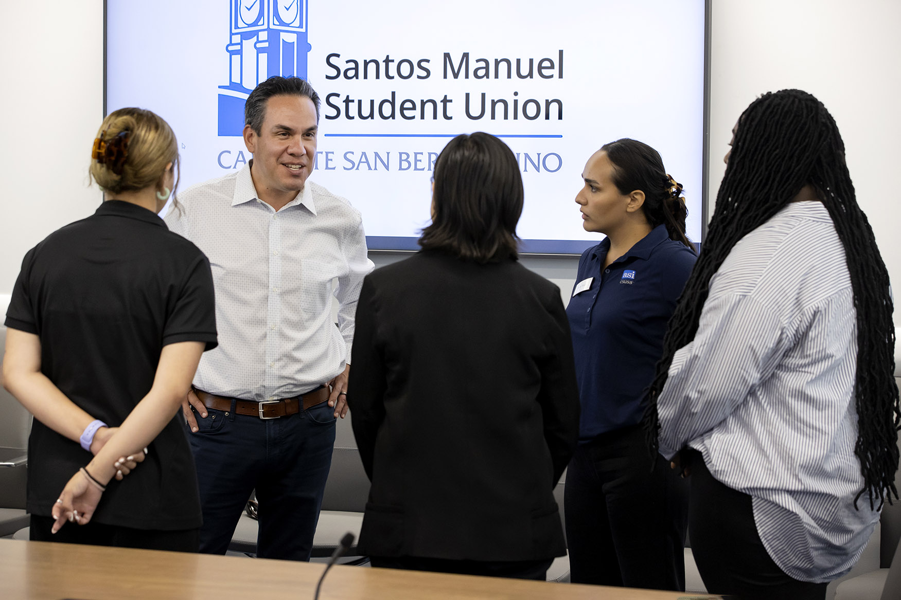 Congressman Pete Aguilar, facing the camera, meets with CSUSB ASI officers