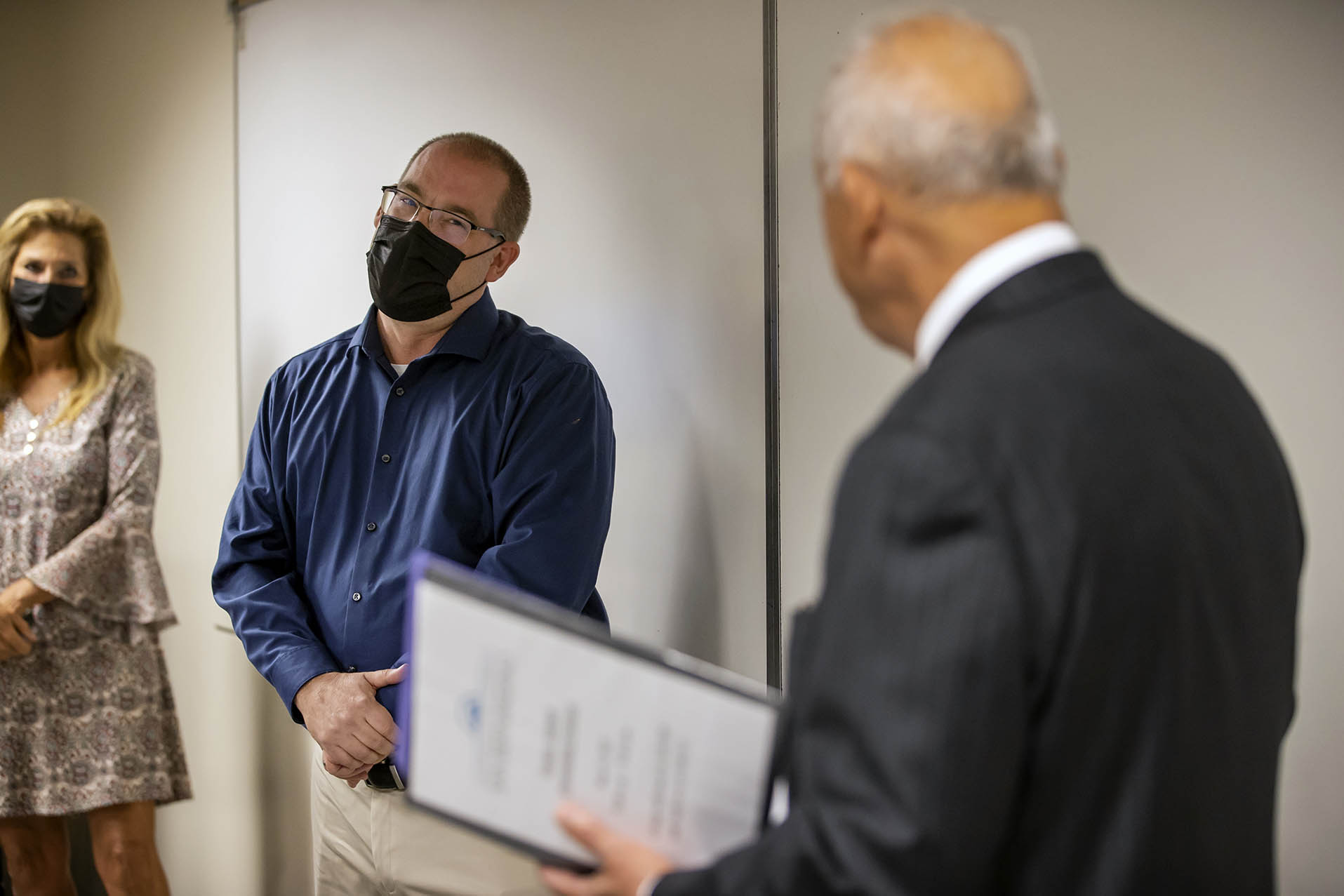 Mark Agars, left, listens as university President Tomás D. Morales announces that Agars is the recipient of the 2021-22 Outstanding Professor award.