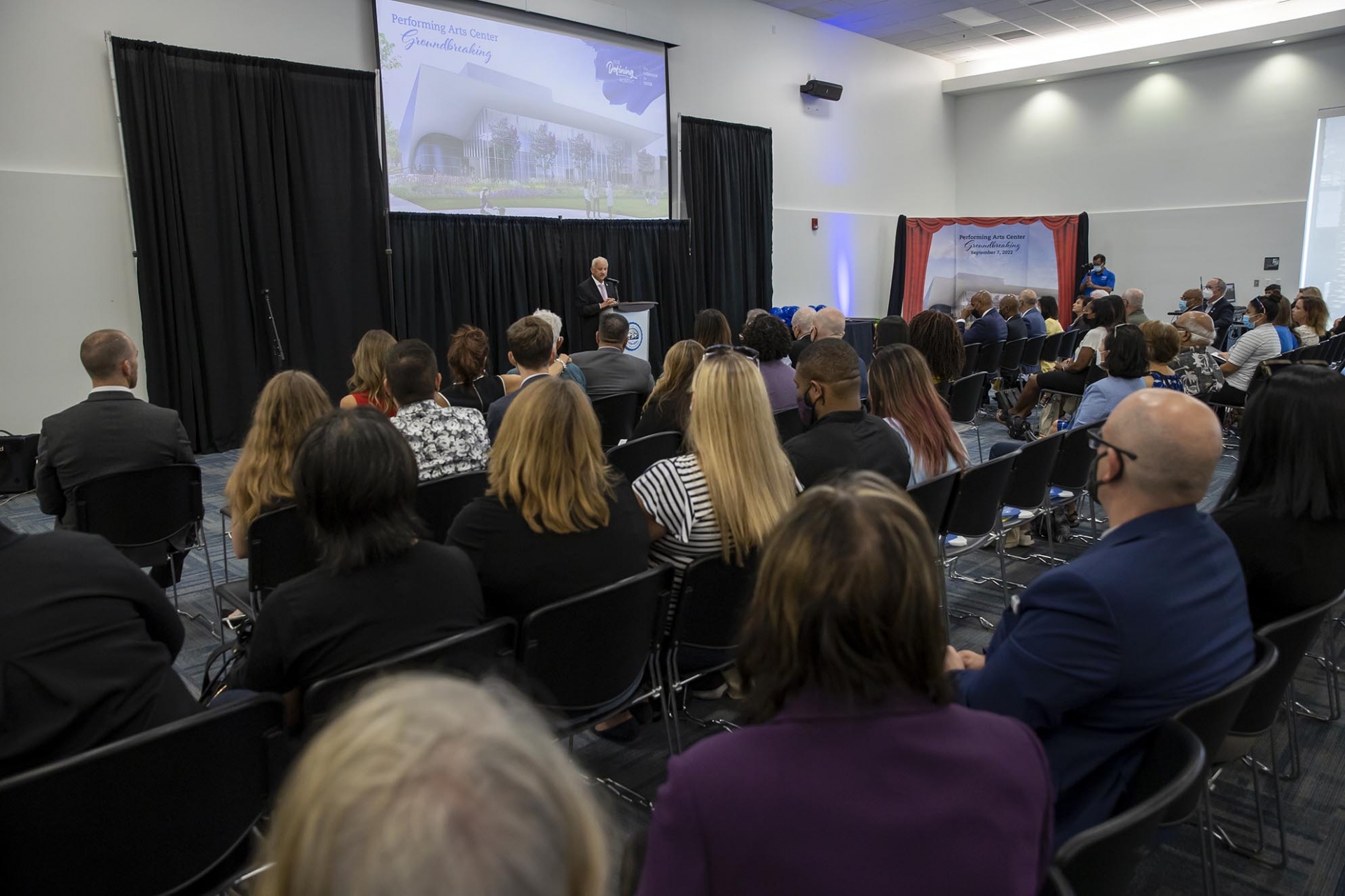 Photo of people during the groundbreaking ceremony for the new Performing Arts Center.