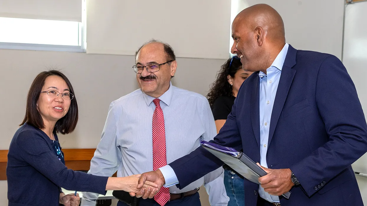 From left, Yan Zhang, associate professor and recipient of the 2024-25 Outstanding Service Award; Khalil Dajani, chair of the School of Computer Science and Engineering; and Provost and Vice President of Academic Affairs Rafik Mohamed.