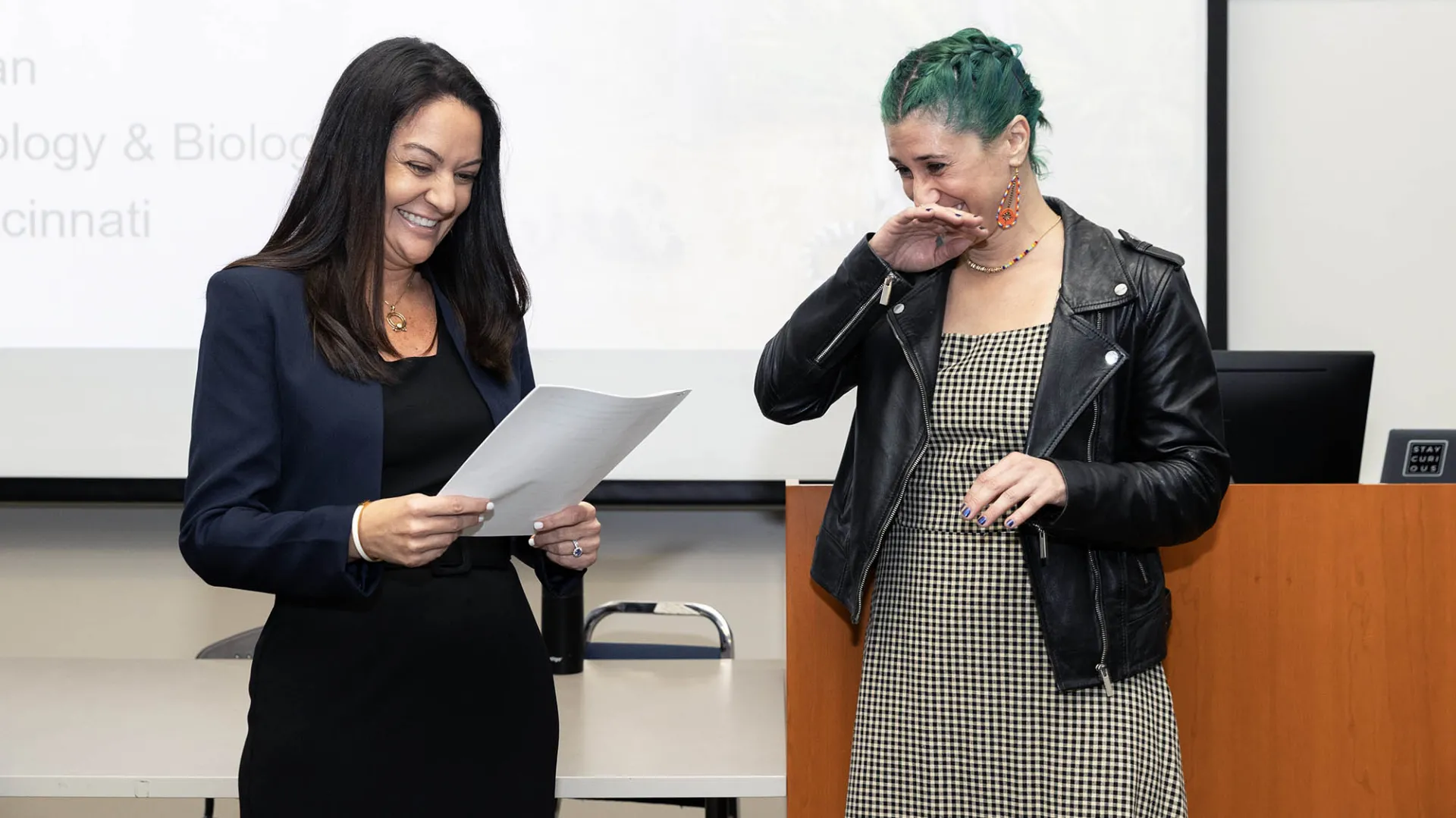Lúa López-Perez (at right), assistant professor of biology, reacts as Kelly Campbell, vice provost for Academic Programs and university co-chief diversity officer, formally announces that López is the university’s 2024-25 Outstanding Faculty Advisor Award recipient.