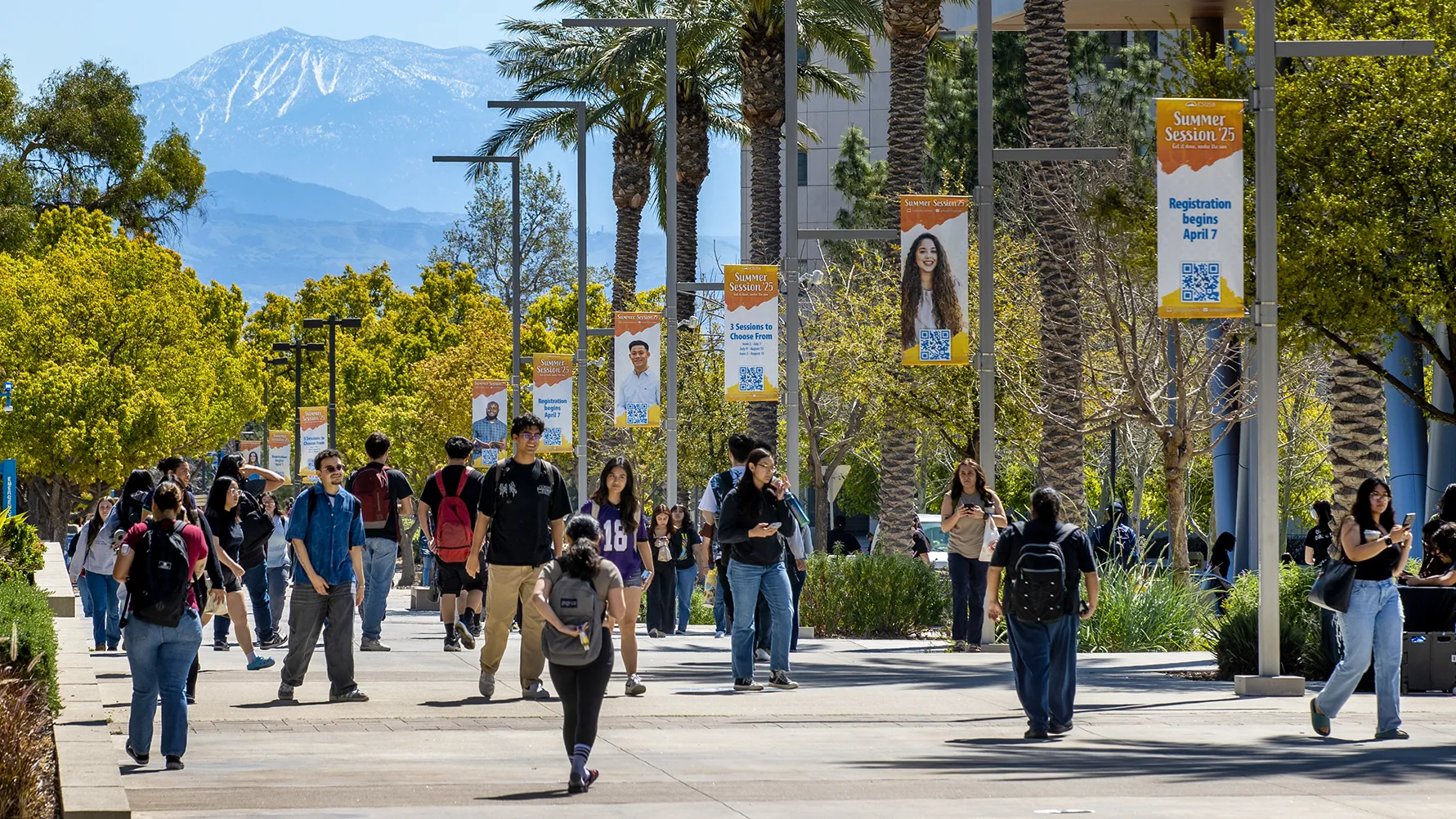 Students make their way on Coyote Walk at CSUSB. 