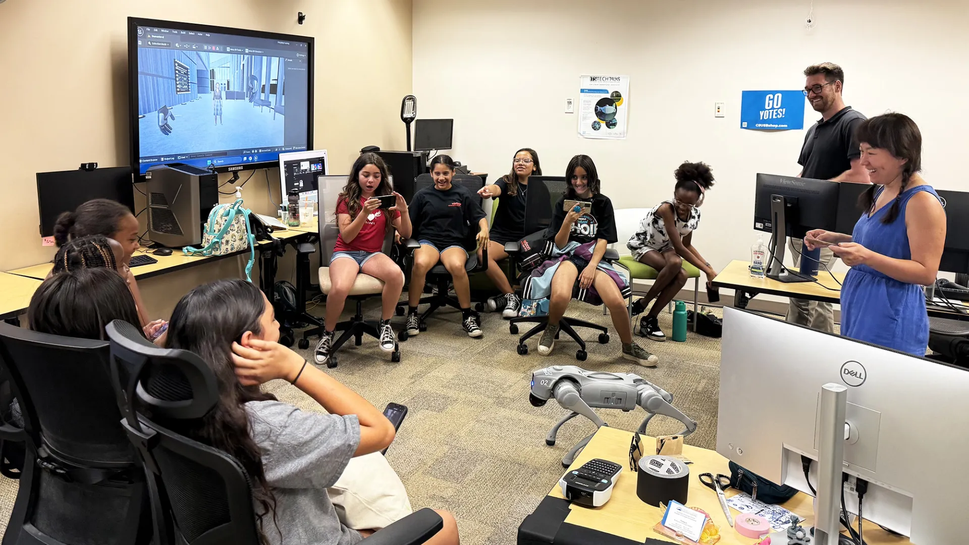 Students in the Verizon Innovative Learning Summer Camp watch a demonstration of a robot dog at the xREAL Lab at CSUSB. 
