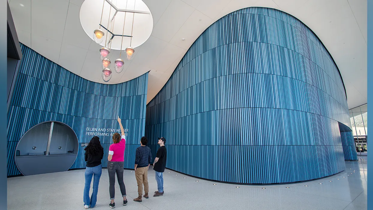 Professor Katherine Gray, second from left, and the three students who helped her create and install the chandelier, admire their handwork.