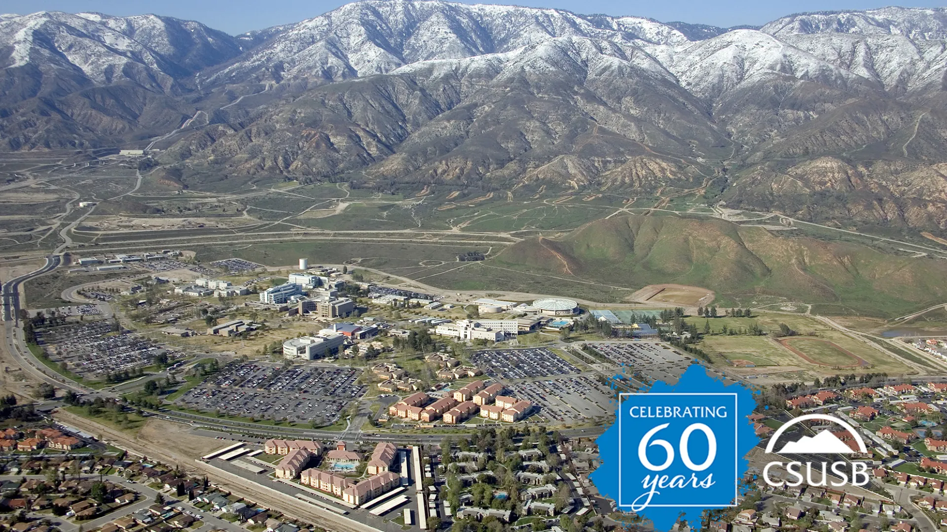 An aerial view of the Cal State San Bernardino campus in the early 2000s, looking toward the snow-capped mountains.