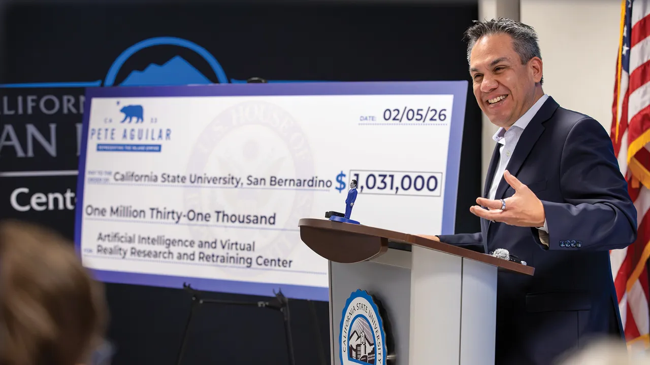 U.S. Rep. Pete Aguilar (CA-33), standing next to a ceremonial check for CSUSB’s Center for Cyber and AI, announces the awarding of the $1,031,000 grant to fund the Artificial Intelligence and Virtual Reality Research and Retraining Center at CSUSB.