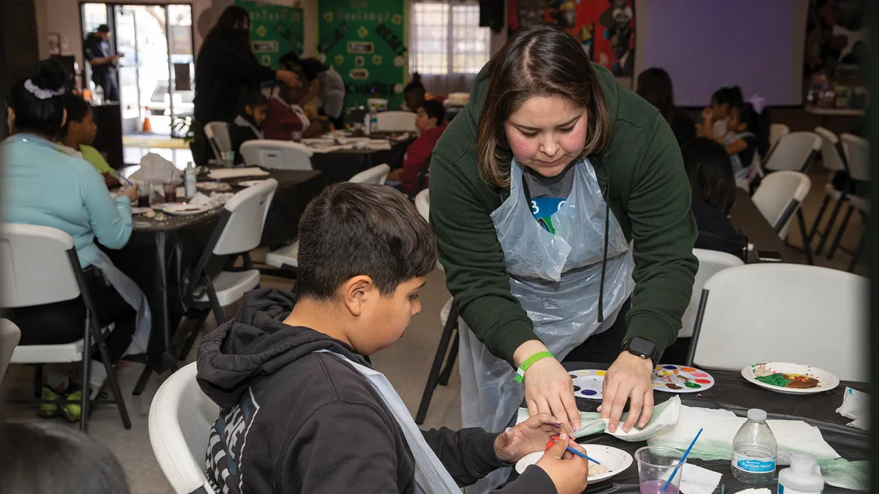 Coyote Cares Day 2023, CSUSB student Keida Velazquez, right, helps youth create art projects at the Akoma Unity Center in San Bernardino. 