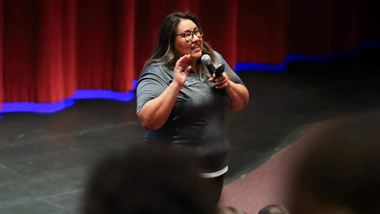 Avi Rodriguez speaking in front of a crowd 