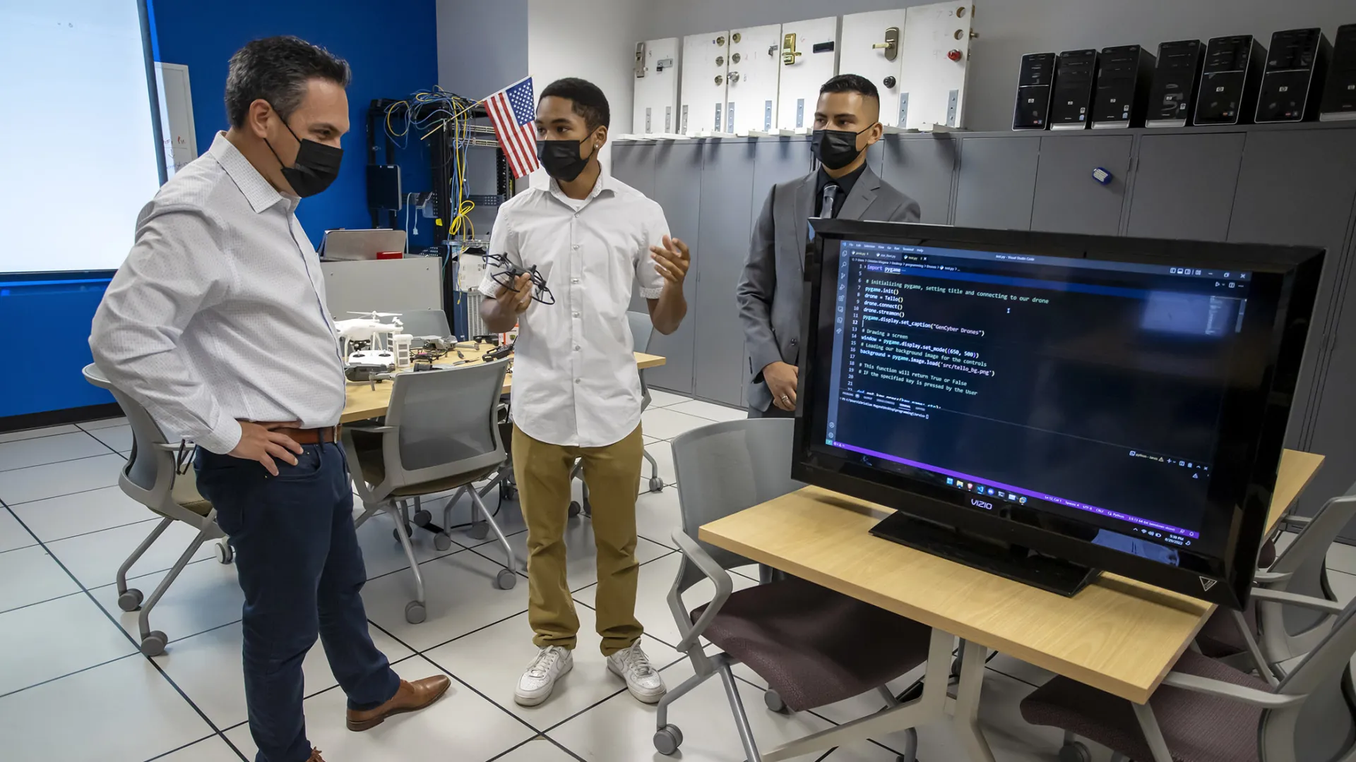 Congressman Pete Aguilar (left) and students at the CSUSB Cybersecurity Center.