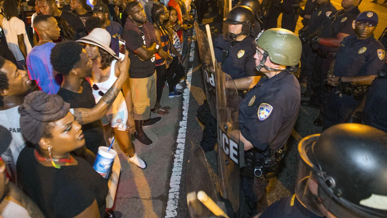 People at a police line during a demonstration.