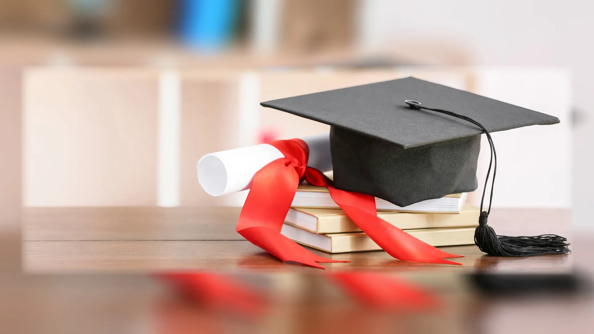Mortarboard and illustration of a diploma