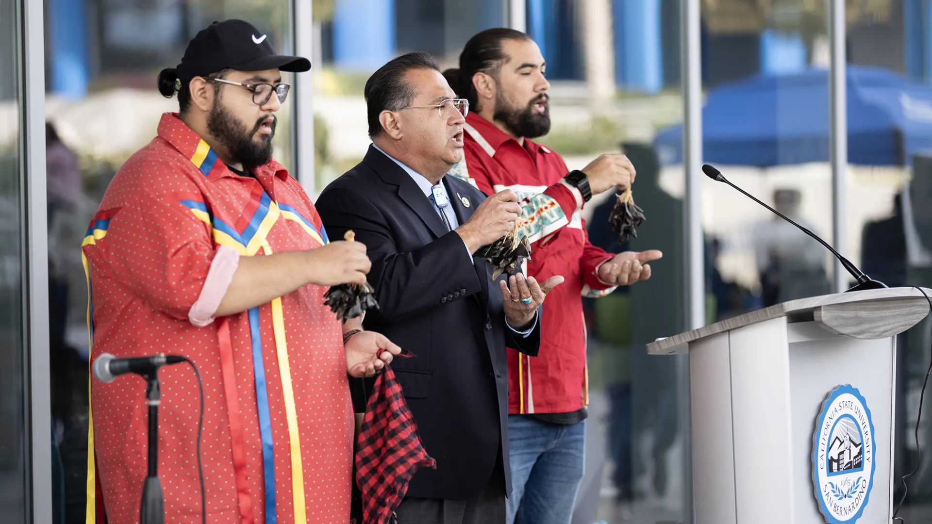 James C. Ramos (center) leading a traditional song at the closing event.