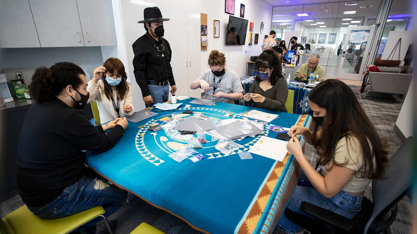 First Peoples’ Center student assistant Daniel Calderon, Guachichil Nation (standing), with students at the center, located in the university’s Santos Manuel Student Union North. 