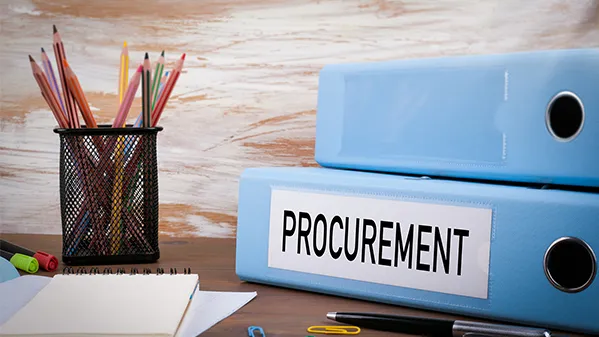 Procurement binder on a desk.