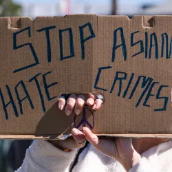 A demonstrator wearing a face mask and holding a sign takes part in a rally in February near LA’s Chinatown.