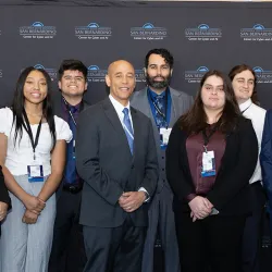 White House Deputy National Cyber Director Harry Wingo (front center with blue tie) posed with students from the Cyber Intelligence & Security Organization (CISO) and the Women in Cybersecurity (WiCyS) campus clubs.