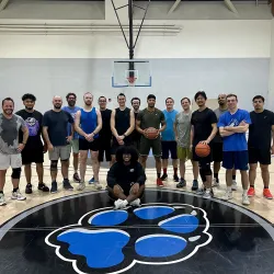 A group of CSUSB students, faculty and staff at the Recreation and Wellness Center basketball court after a game. The informal pickup games are continuing through the summer. More players are welcome.