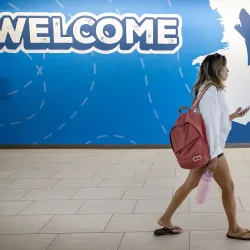 Two students walk by a welcome sign