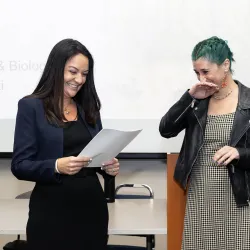 Lúa López-Perez (at right), assistant professor of biology, reacts as Kelly Campbell, vice provost for Academic Programs and university co-chief diversity officer, formally announces that López is the university’s 2024-25 Outstanding Faculty Advisor Award recipient.