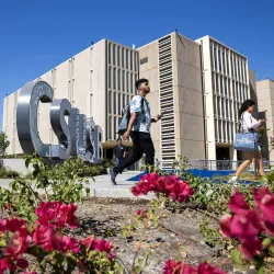 Students make their way past the John M. Pfau Library. U.S. News & World Report has again recognized CSUSB’s graduate criminal justice and MBA online programs as among the best in the nation.