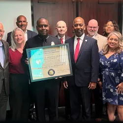 CSUSB Police Chief John Guttierez, surrounded by university administrators, holds a plaque from the  International Association of Campus Law Enforcement Administrators that officially recognizes that the University Police Department has been accredited.
