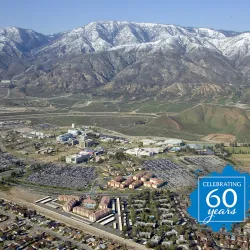 An aerial view of the Cal State San Bernardino campus in the early 2000s, looking toward the snow-capped mountains.