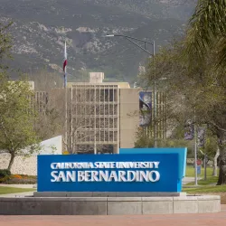 John M. Pfau Library and the California State University San Bernardino entrance sign on University Parkway.