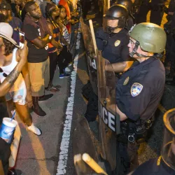 People at a police line during a demonstration.