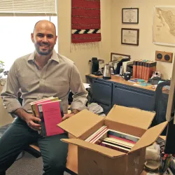 Professor showing books