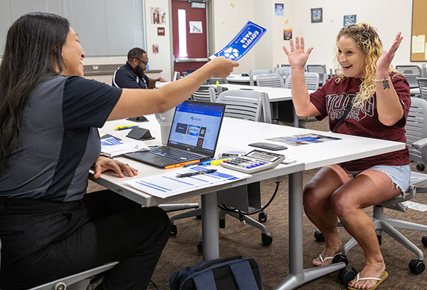 A student is granted a “Coyote Pass” by a CSUSB admissions counselor. 