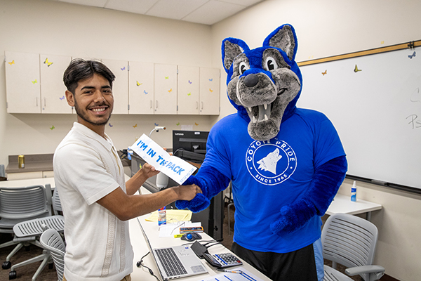 Cody congratulates a student on earning a “Cody Pass” at Instant Admit Days. 