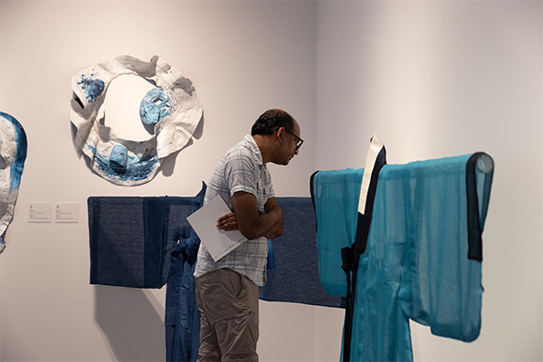 An attendee studies a piece from the “Korean Craft: Yesterday and Today” exhibit.