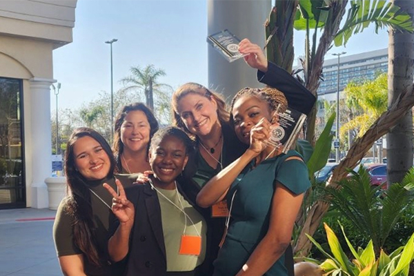 The JHBC graduate team, left to right, Bianca Serrano, Rochelle Reynoldson, Olayinka Owoseni, Molly Riter (with award) and Omotola Akanni (with award).