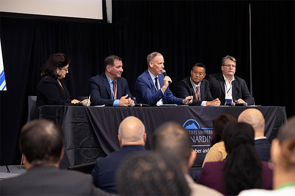 A panel discussion featured (from left) Dr. Diba Hadi, principal director from the Department of Defense’s Cyber Academic Engagement Office; Dr. Vincent Nestler, director of CSUSB’s Center for Cyber and AI; Dr. Dale Marsden, CEO of Tomorrow’s Talent; Richard Watanabe, digital engineering department manager, Naval Surface Warfare Center, Port Hueneme; Heidjer Staecker, partner at NXL Cyber, Tremonti Consulting.