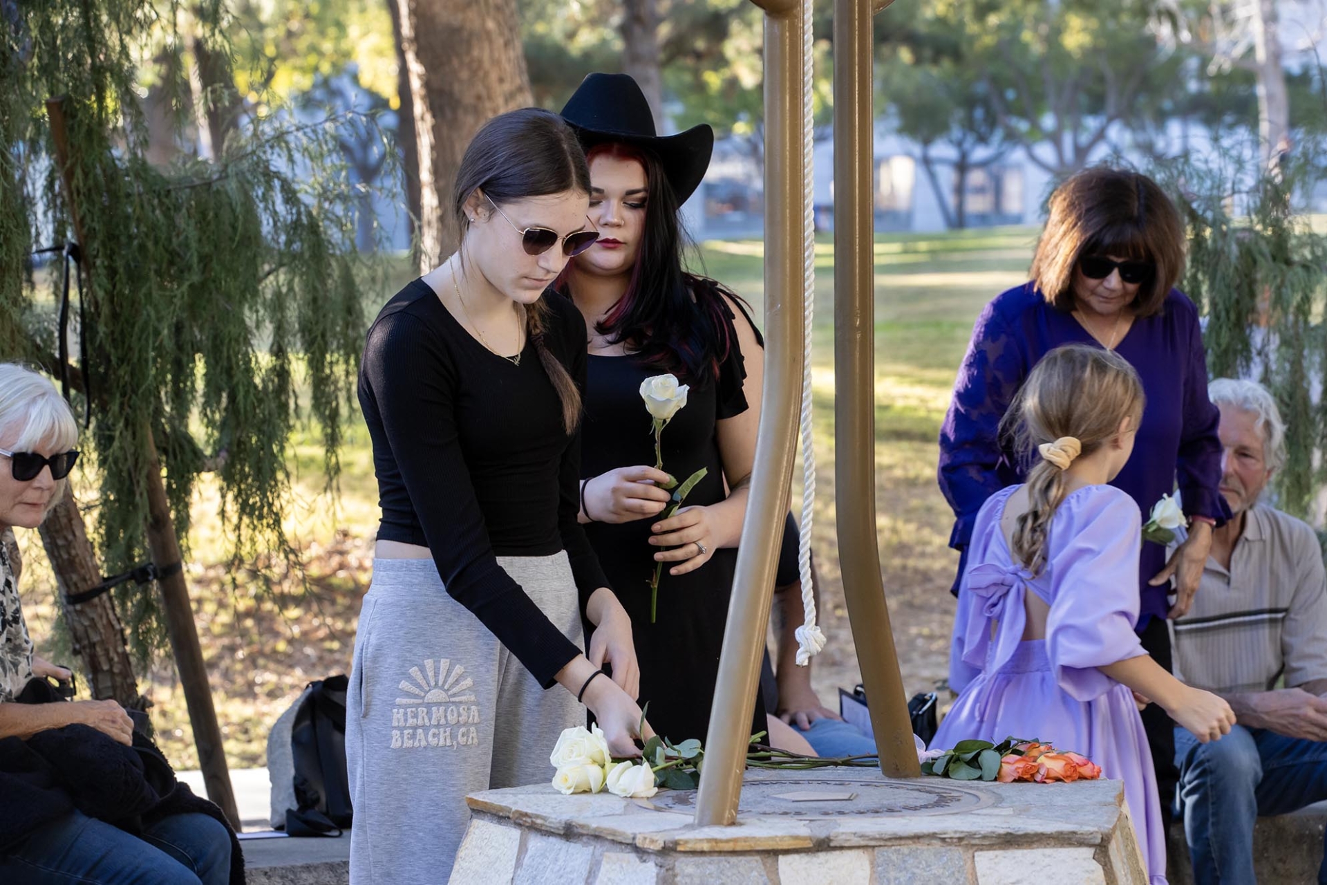 Family members and friends laid roses at the base of the Peace Garden bell on Dec. 2.