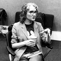 Alison Phipps, black and white photo, white woman in blazer, lecturing, seated, coffee cup