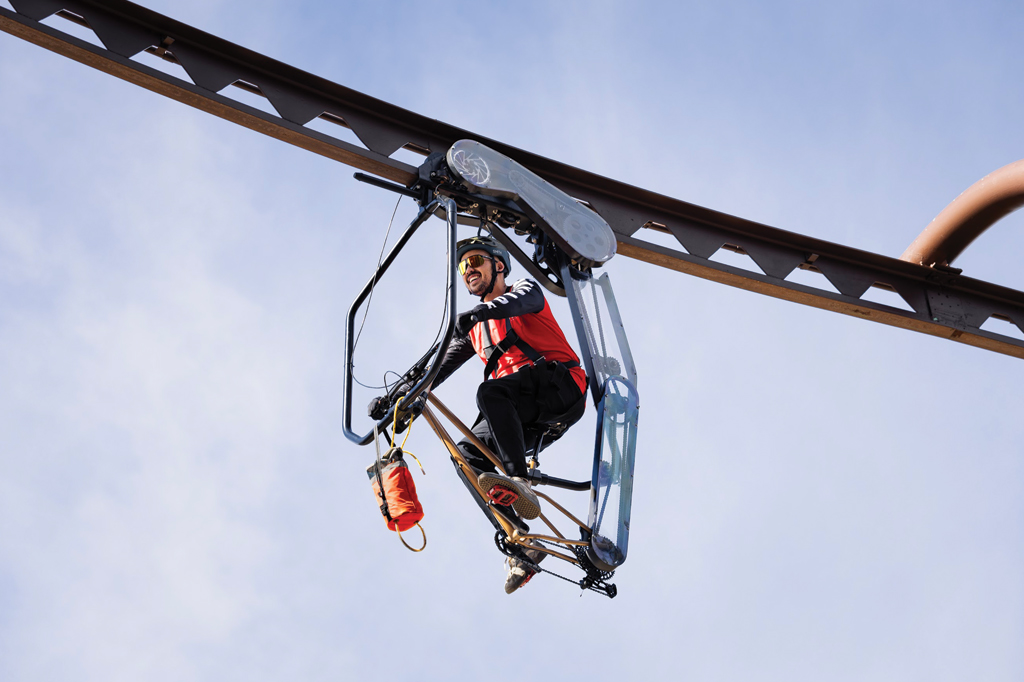 man on B rail bike under track 30 feet in air