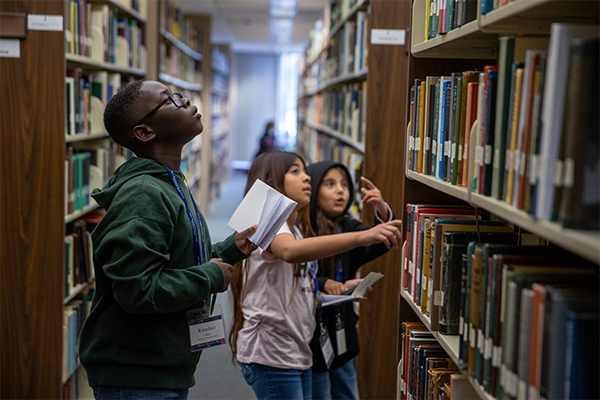 A group of middle school students make their way through the bookstacks at Cal State San Bernardino’s John M. Pfau Library during San Bernardino County History Discovery Day on Nov. 14.