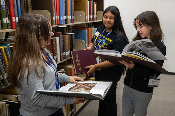 A group of middle school students make their way through the bookstacks at Cal State San Bernardino’s John M. Pfau Library during San Bernardino County History Discovery Day on Nov. 14.