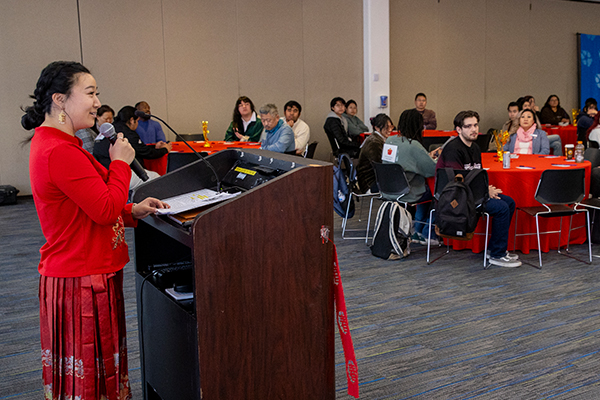 Lucy Li, YOURS AANHPI Program advisor, welcomes the crowd during the Lunar New Year Celebration hosted by the YOURS AANHPI Program.