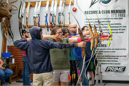 5 students aiming at wall