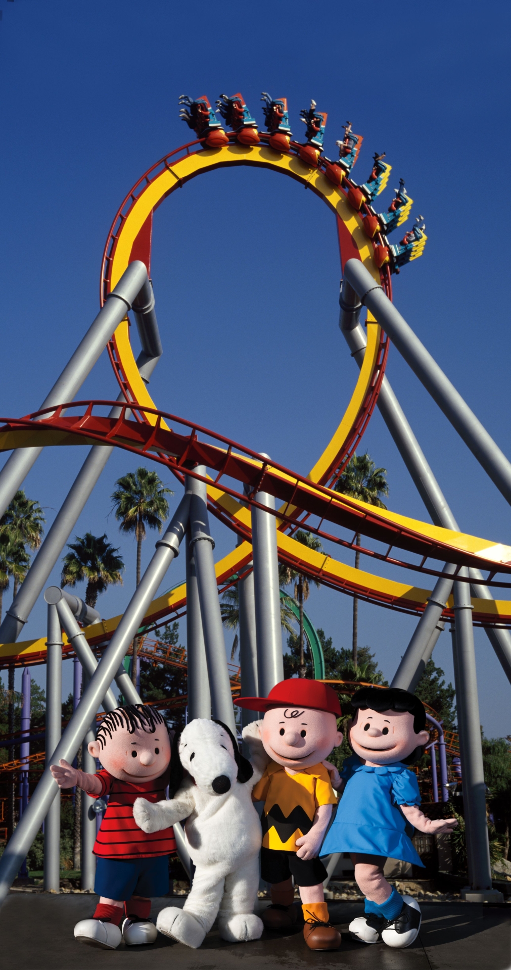 Peanuts character in front of roller coaster