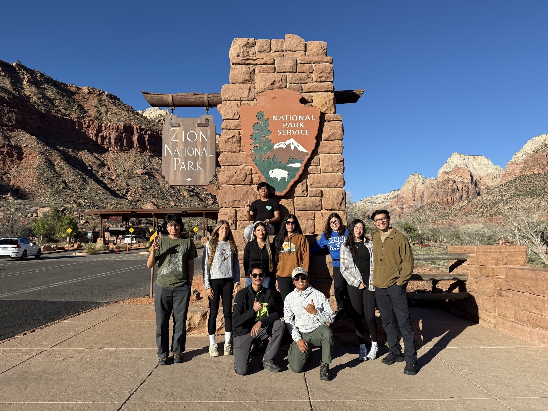 group of people in front of Zion sign