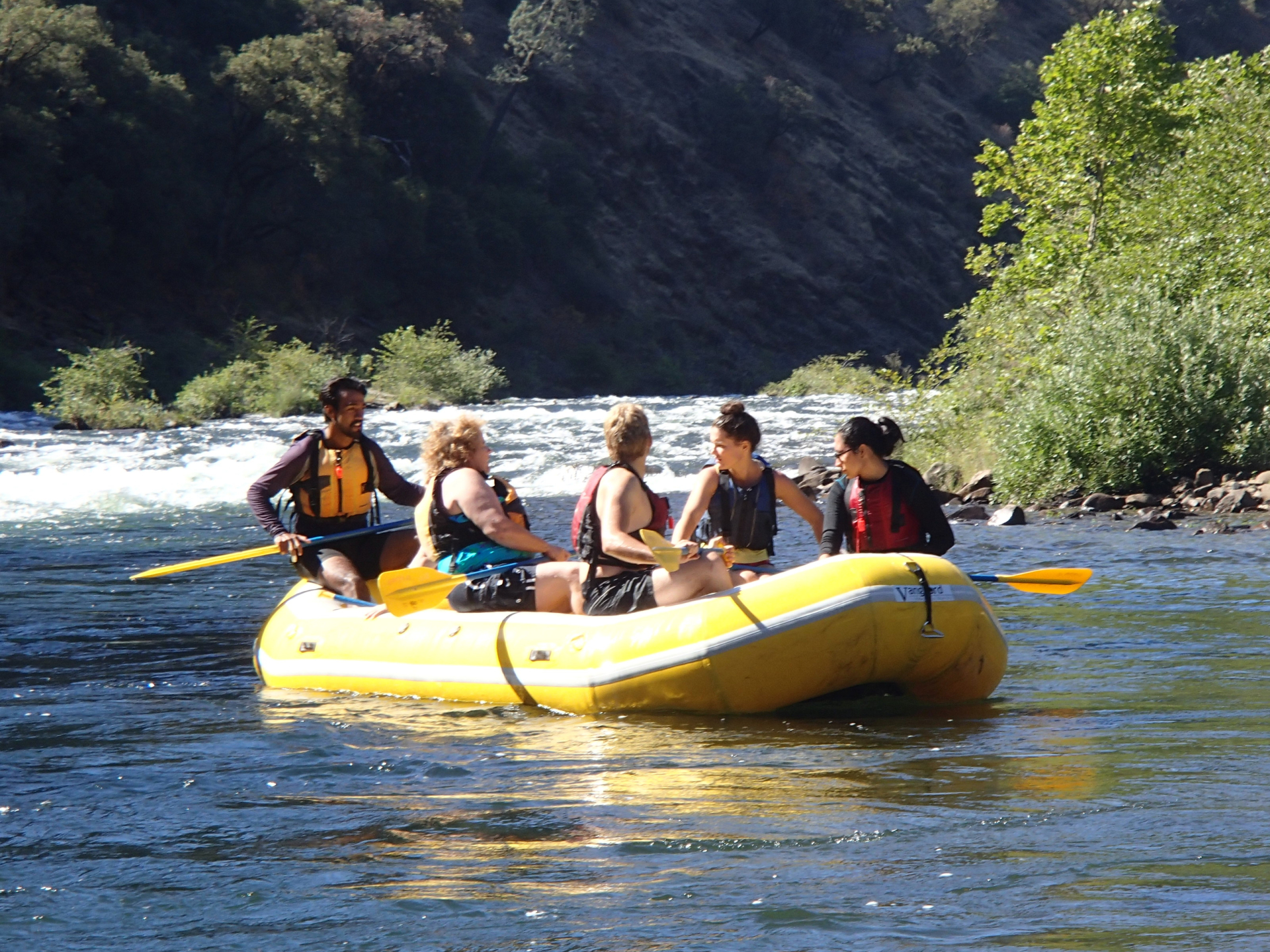 boat floating in river with paddlers