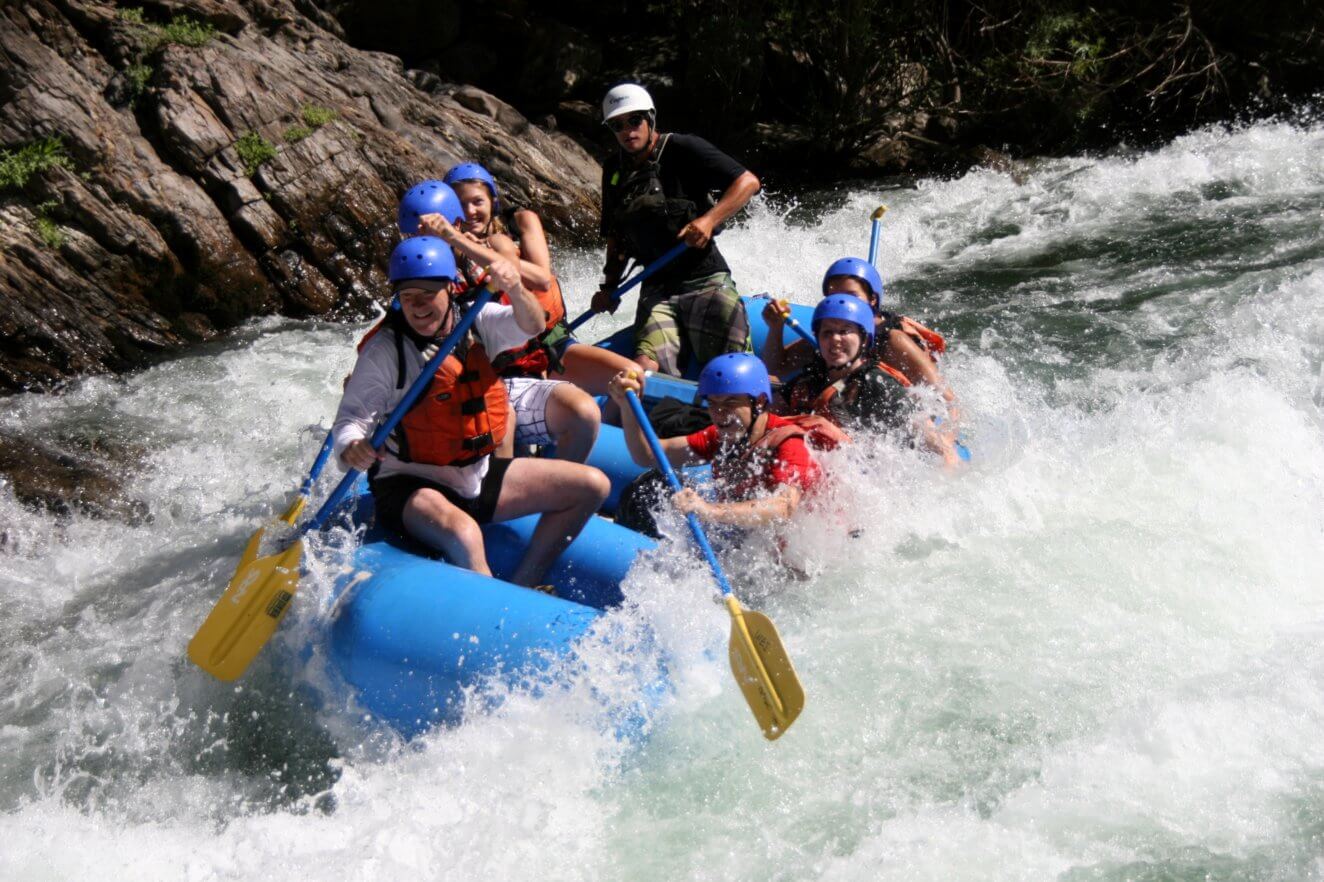 paddling a raft in rapid