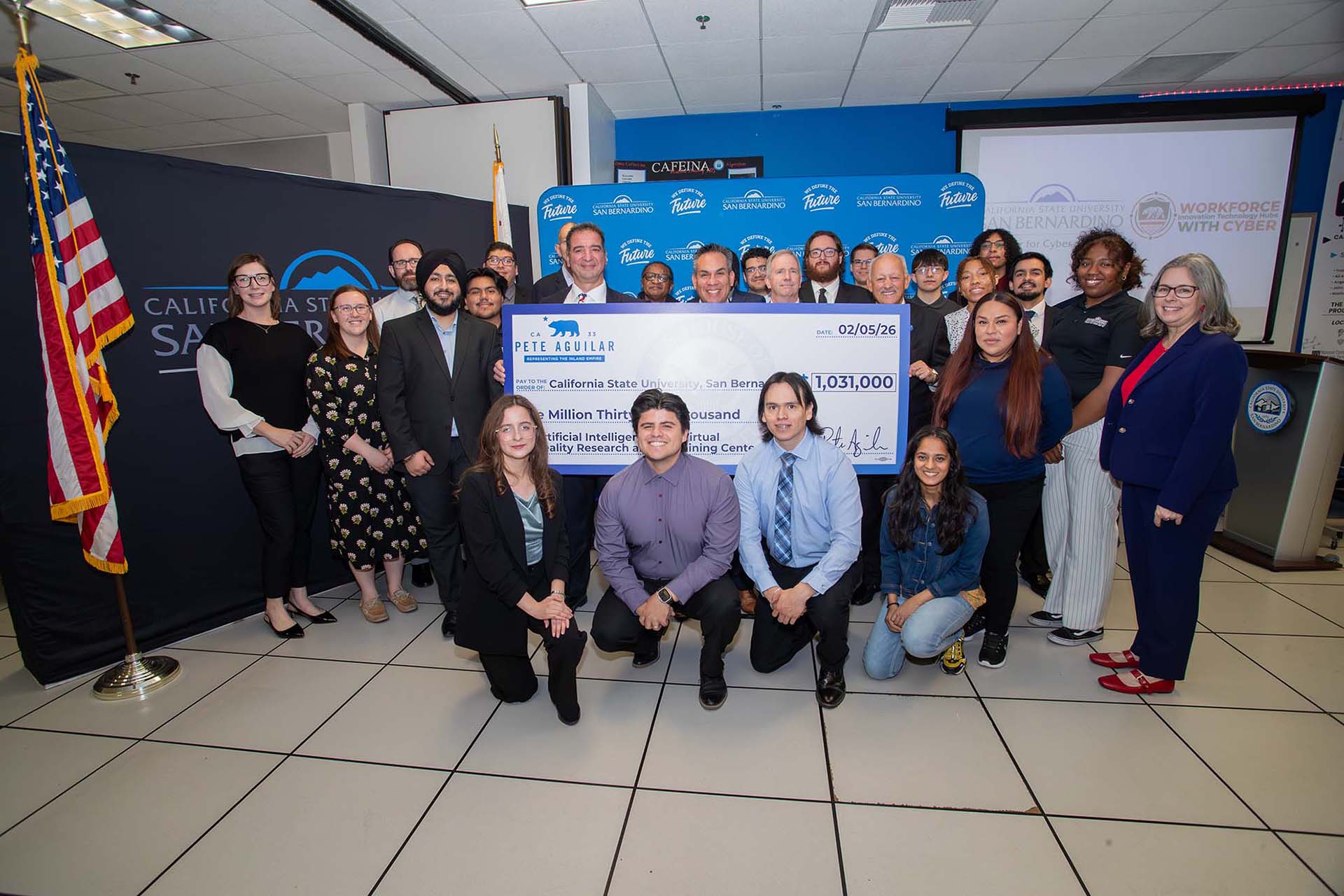 CSUSB students, faculty and staff, along with (from left holding the ceremonial check) Vincent Nestler, director of the CSUSB Center for Cyber and AI; U.S. Rep. Pete Aguilar, Tony Coulson, executive director, Center for Cyber and AI; and Tomás D. Morales, CSUSB president.