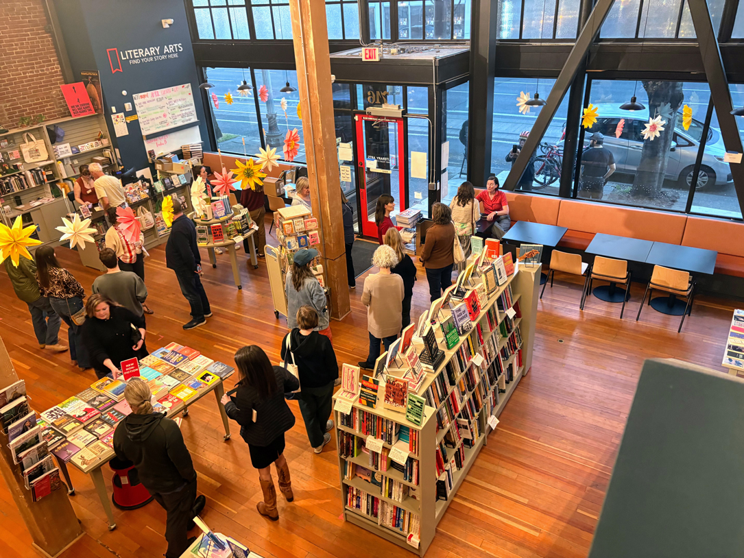 Author Robyn Saunders Wilson, seated in red top, at a signing for her book, "Junkyard Princess."