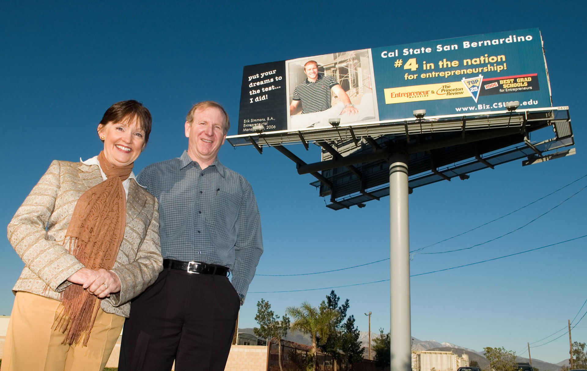 Karen Bowerman, then dean of the College of Business and Public Administration, and Mike Stull, director of the Inland Empire Center for Entrepreneurship, at a billboard promoting CSUSB’s No. 4 national ranking by Entrepreneur magazine.